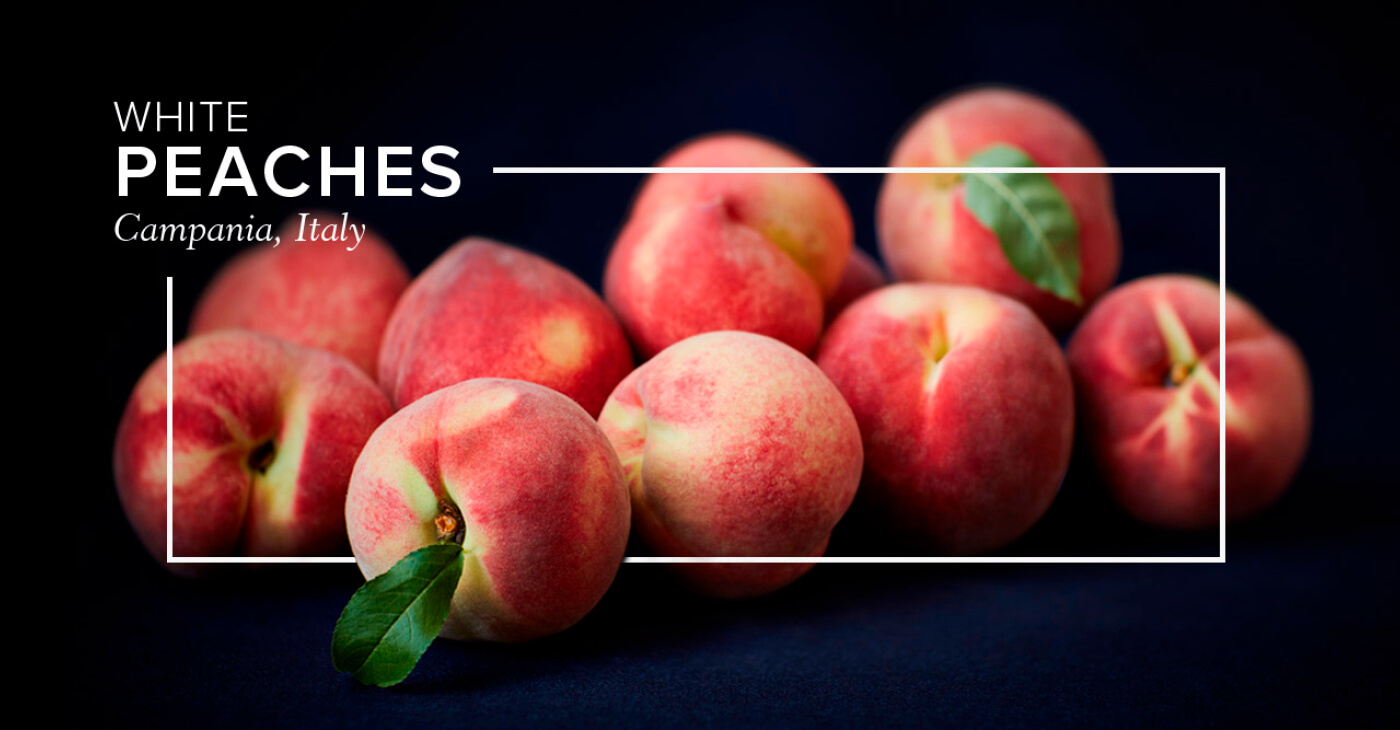 White 'White Peaches' heading and rectangular frame on a black background, intertwined with Italian peaches