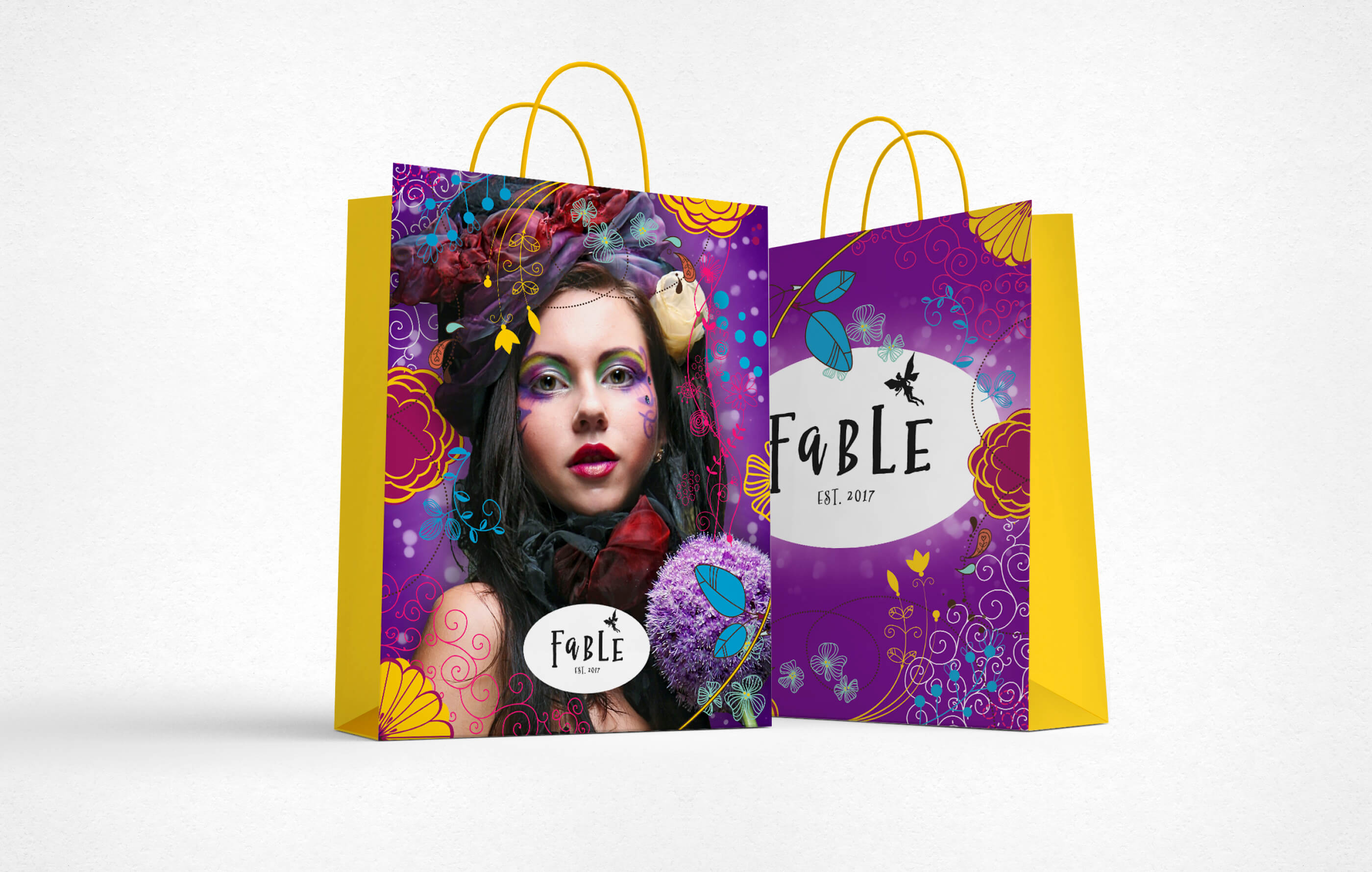 Paper shopping bag mock up, with illustrations on a purple background on the front and back and contrasting yellow sides