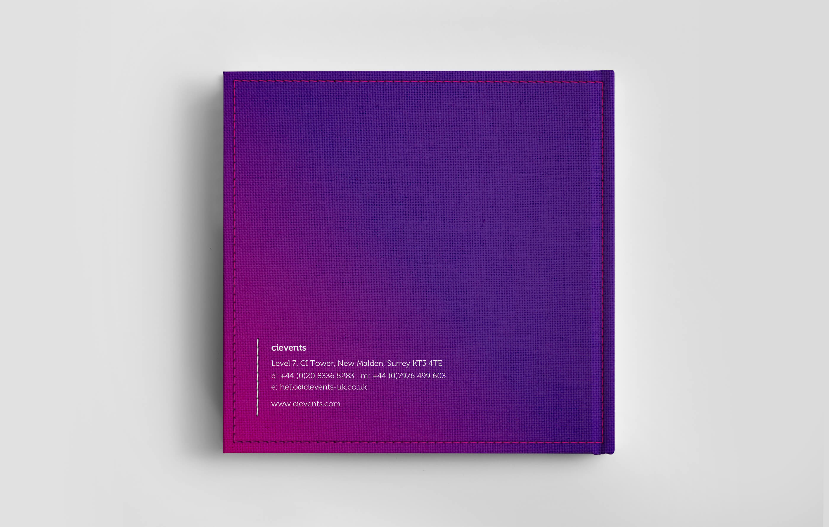 Hardback back cover of the square DFS proposal brochure, wrapped in a purple and pink coloured fabric