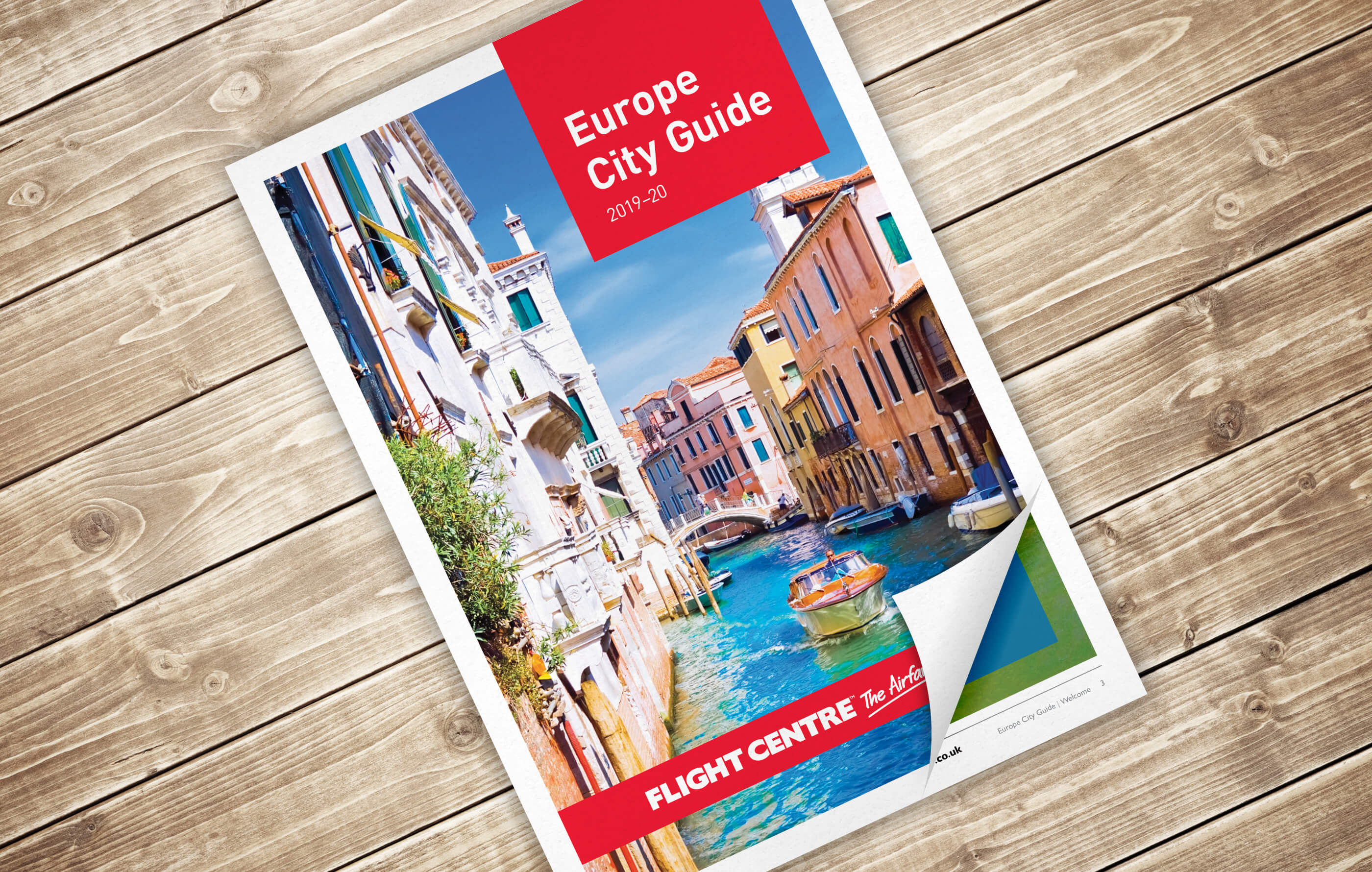 Europe City Guide brochure front cover, featuring a sunny shot of a canal in Venice with boats moared along its sides