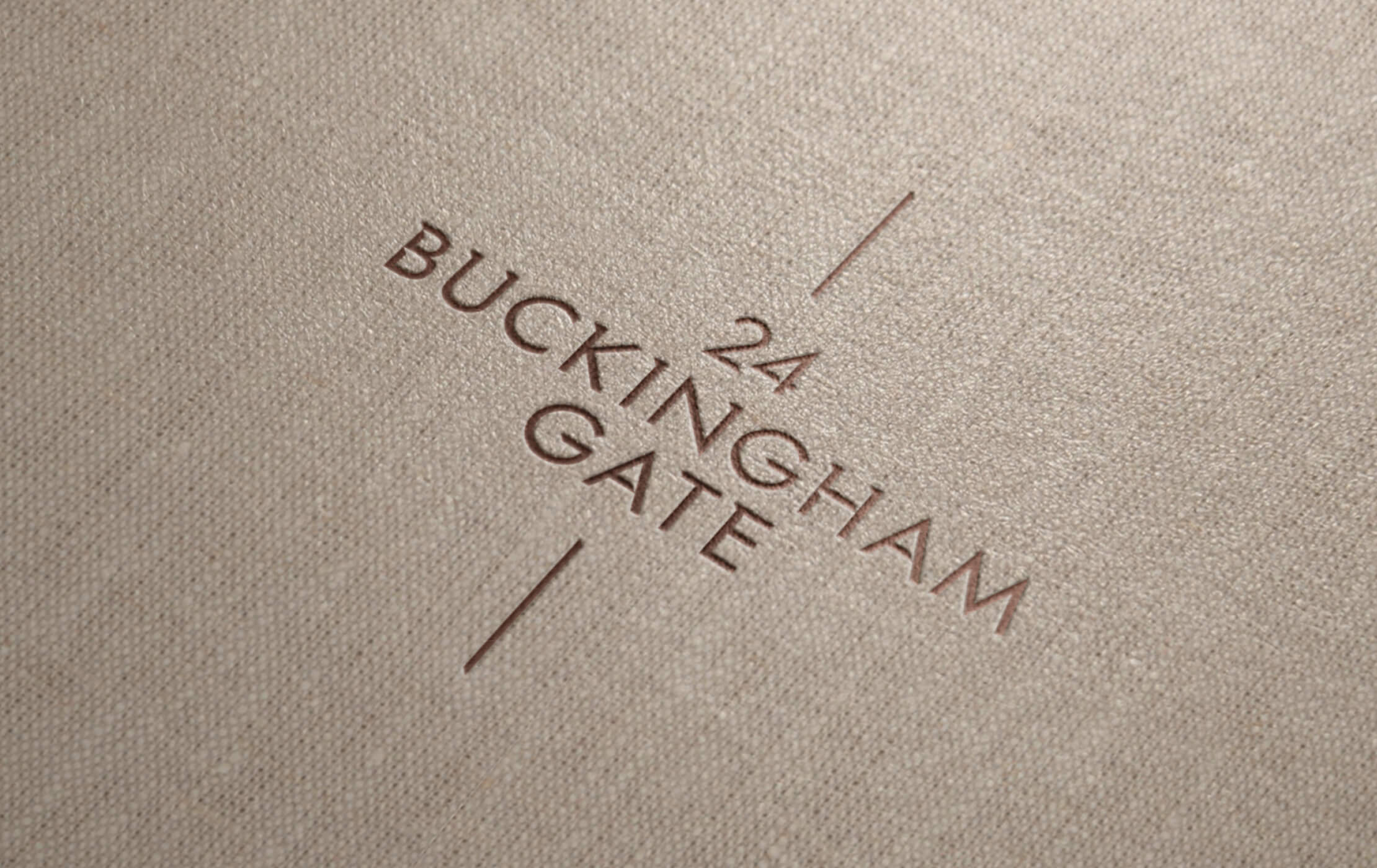 Brown and gold 24 Buckingham Gate logo embossed onto a cloth wrapped brochure cover