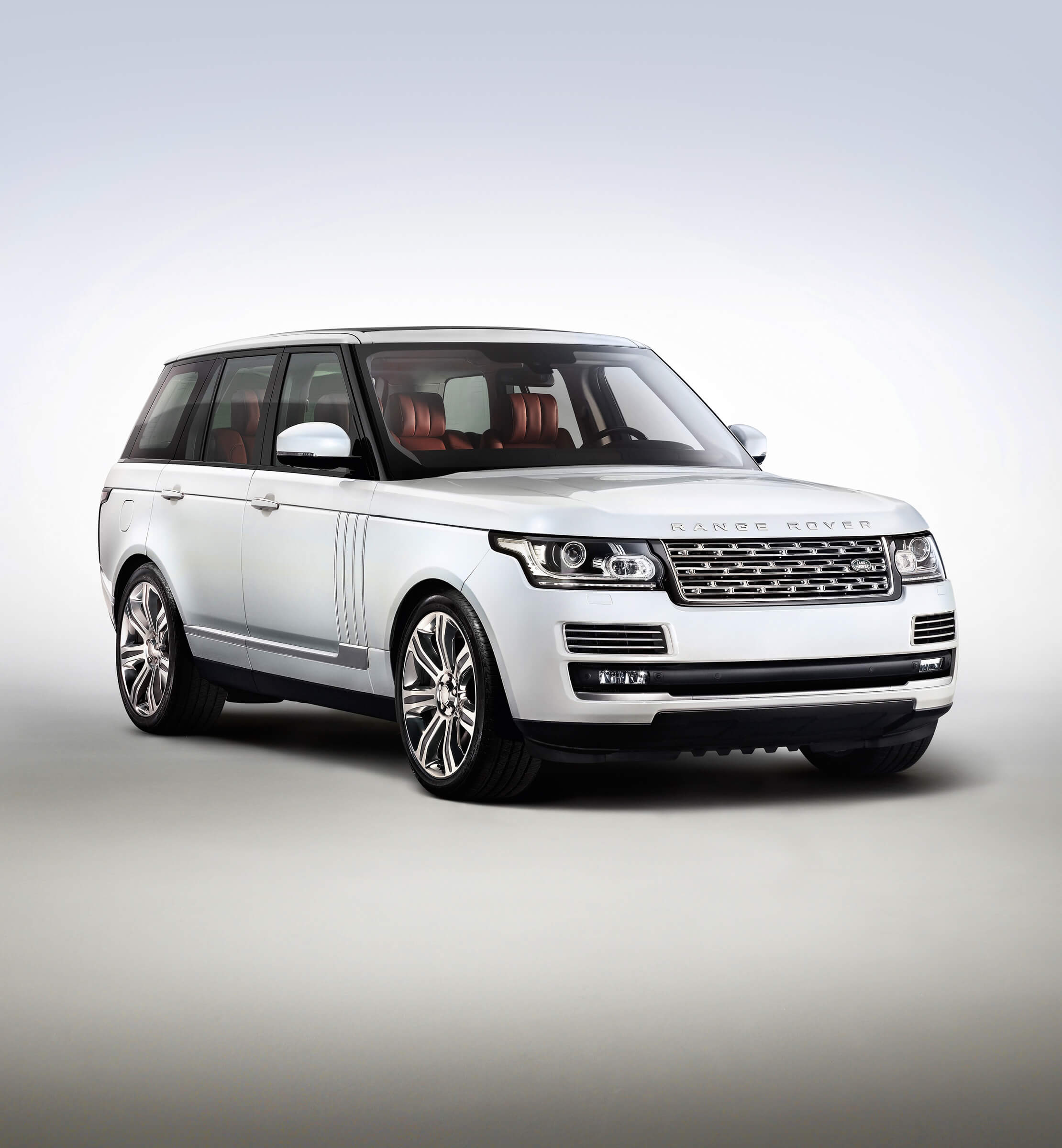 Profile shot of a white Land Rover Range Rover, with red leather interior on a blue and grey background
