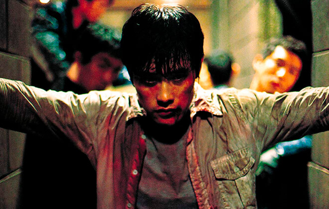 Shot from the film, depicting Sun-woo (Byung-hun Lee) standing bloodied and battered in a dark corridor
