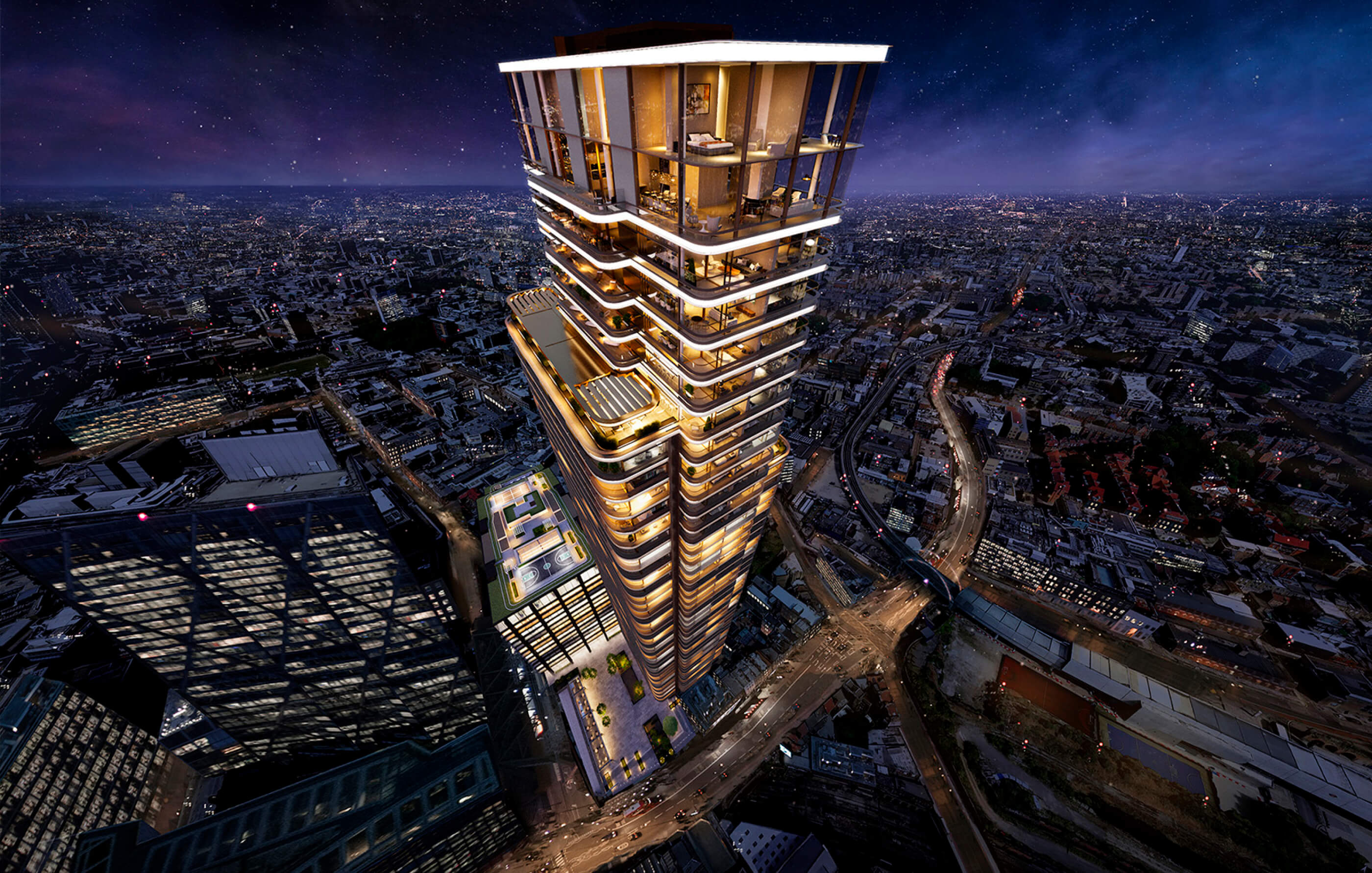Aerial view of Principal Tower at night with the penthouse illuminated, looking down at the city lights of London below