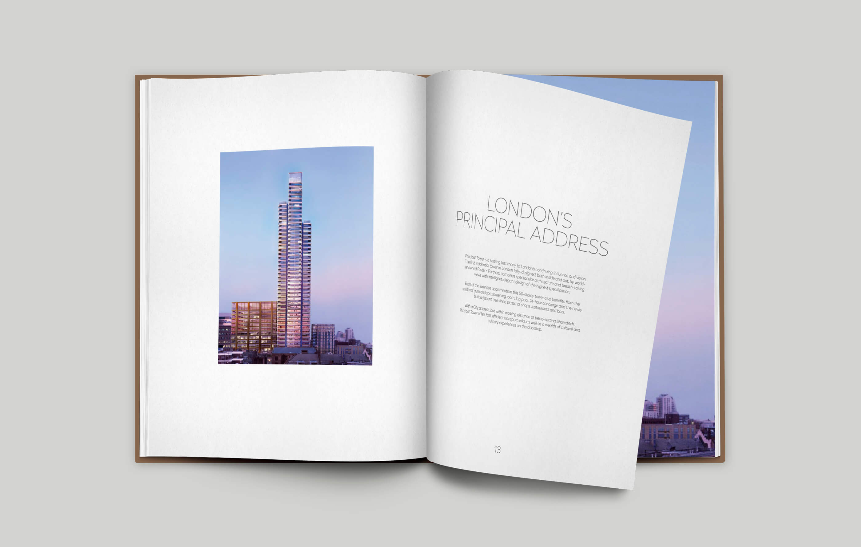 Open brochure spread on a grey background highlighting the development's prime location and principal address in EC2