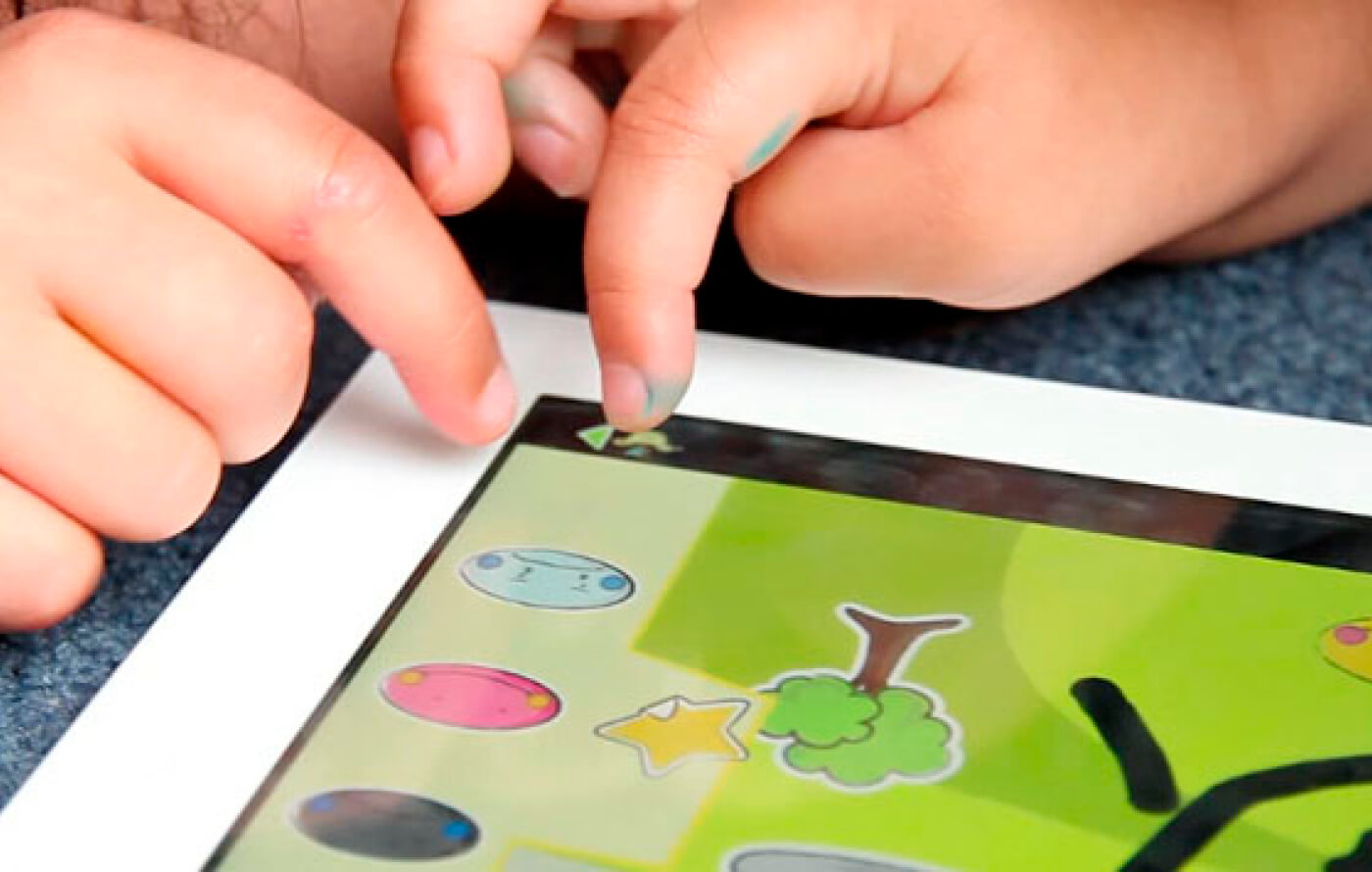 Close up image of two children's fingers tapping on part of the game on an iPad screen