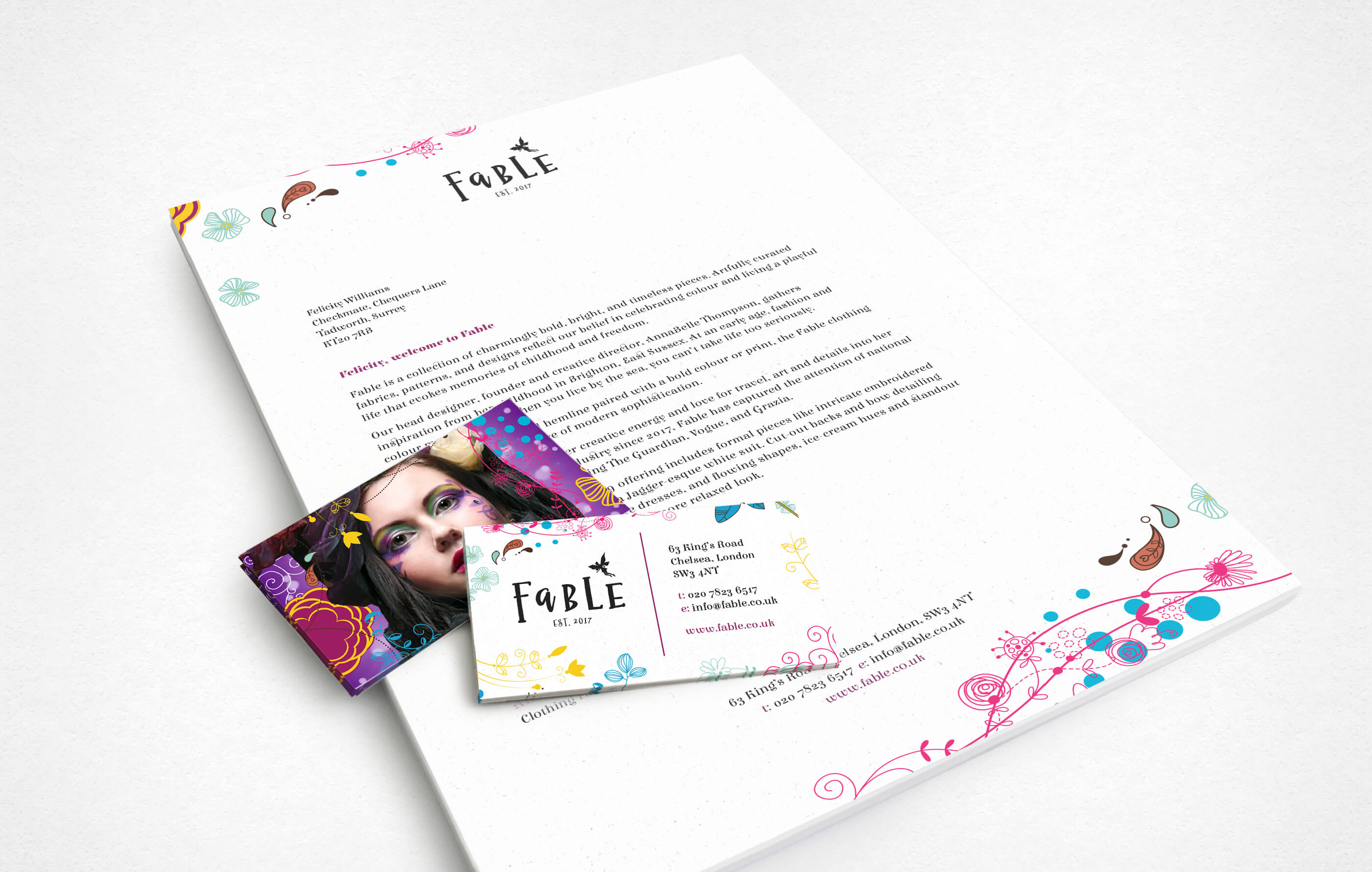 Mock up of Fable branded stationery, including letterhead and both sides of a business card on a white background