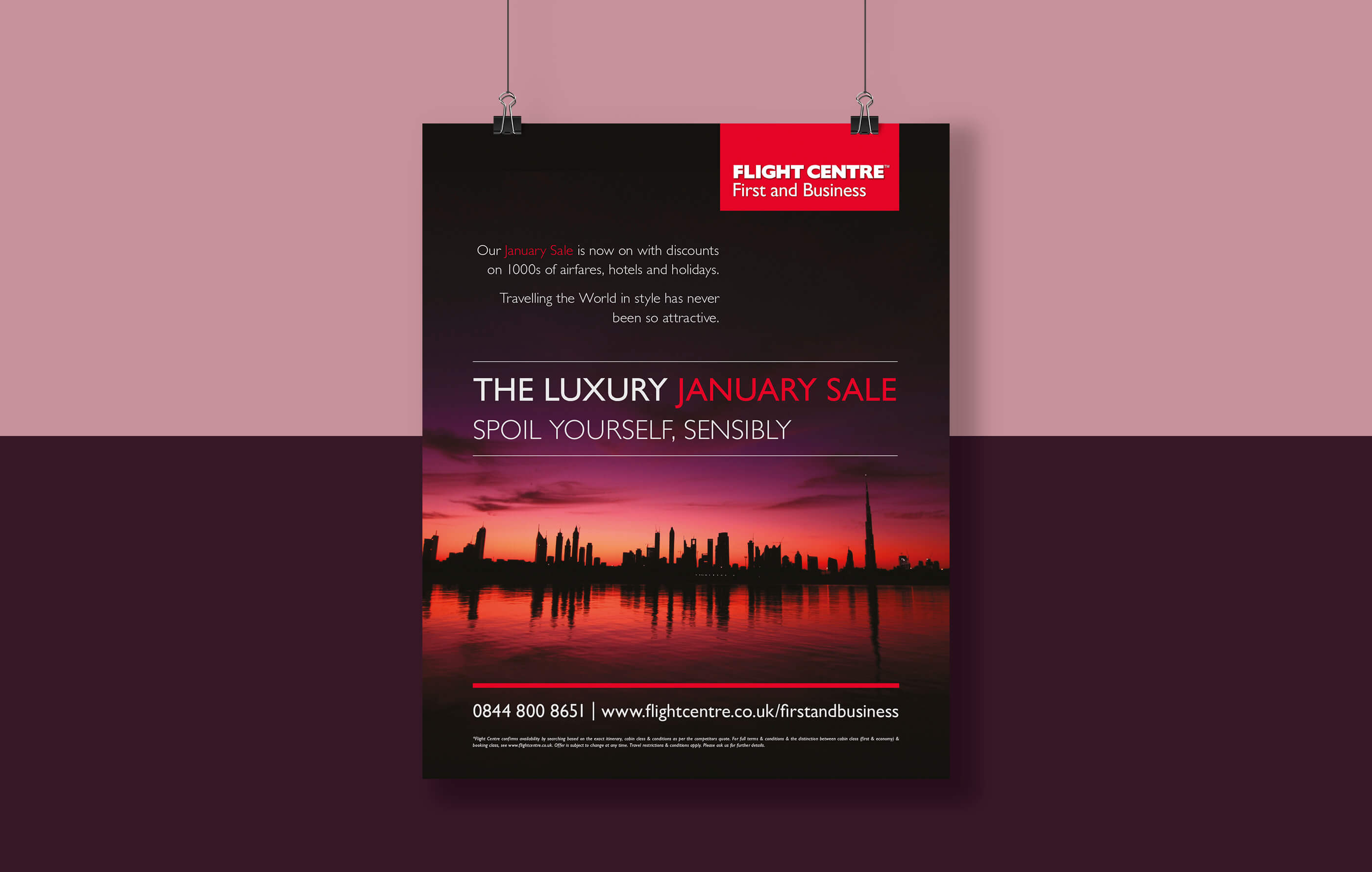 Spoil Yourself Sensibly luxury January sale poster hung on clips, set against a horizontal pink and purple background'